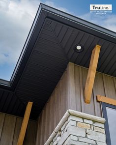 the side of a building with a cross on it's roof and windows above