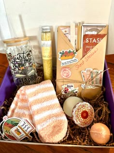 a box filled with lots of food on top of a wooden table