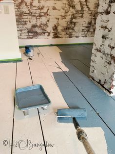 the floor is being painted and ready to be used as a wallpapering project