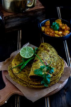 there are some food that is on top of a wooden board and next to other foods