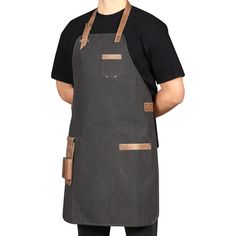 a man wearing an apron and black t - shirt