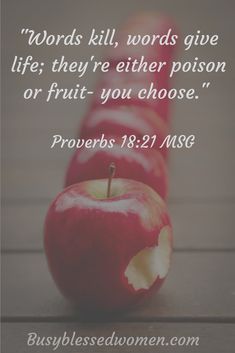 three red apples sitting next to each other on top of a wooden table with a bible verse