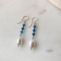 Like the clear blue waters of the ocean get lost in these Blue Apatite and Freshwater Pearl dangle earrings. The stunning faceted Blue Apatite gemstones have the most captivating transparent blue color to them. They are paired with organically shaped freshwater pearls to give you that tropical/coastal vibe. Both the Blue Apatite and Freshwater Pearls are superior AAA grade gemstones (the best you can get!) That is why the Blue Apatite has that dreamy transparent deep blue color, and the pearls h Cheap Blue Pearl Drop Jewelry, Bracelet Inspo, Freshwater Pearl Drop Earrings, Pearl Dangle Earrings, Earring Ideas, Blue Apatite, Pearl Earrings Dangle, Wrapped Jewelry, Basket Ideas