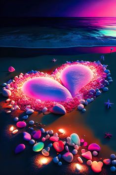 two hearts on the beach surrounded by sea shells and starfish at night with colorful lights