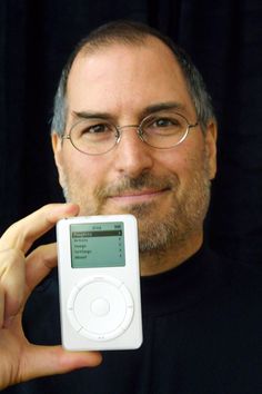 a man holding an ipod in front of his face with the words world news on it