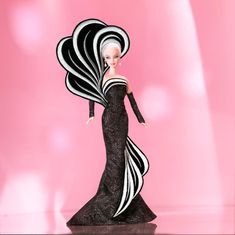 a barbie doll wearing a black and white dress with feathers on it's head