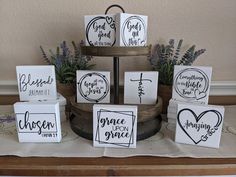 a table topped with boxes filled with different types of cards and flowers on top of a wooden tray