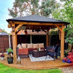 a wooden gazebo sitting on top of a lush green field