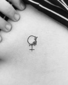 a woman's stomach with a small tattoo on it