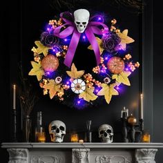 a halloween wreath with skulls and flowers on the mantle in front of a fire place