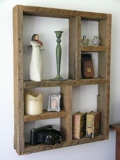 three wooden shelves with books, vases and other items on top of each shelf