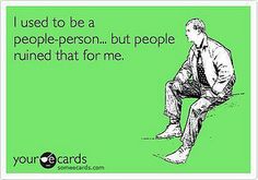 a man sitting on the ground in front of a sign that says i used to be a people - person but people ruined that for me