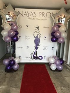 balloons and streamers are set up in front of a backdrop for a fashion show