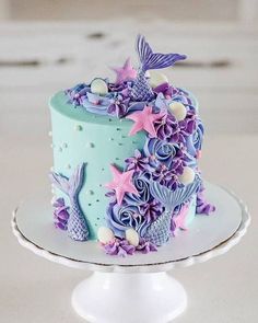 there is a cake decorated with purple and blue decorations