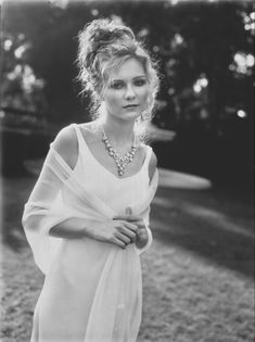 an old photo of a woman in a white dress