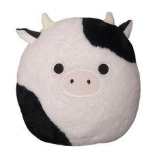 a black and white cow stuffed animal on a white background