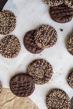 chocolate cookies with sprinkles sitting on parchment paper