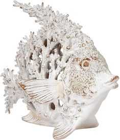 a white ceramic fish with corals on it's side