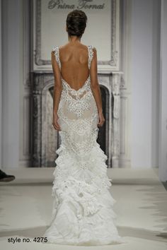 the back of a wedding dress with ruffled skirt and open - back neckline