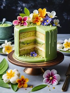 a green cake with flowers on top