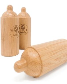 two wooden salt and pepper shakers next to each other