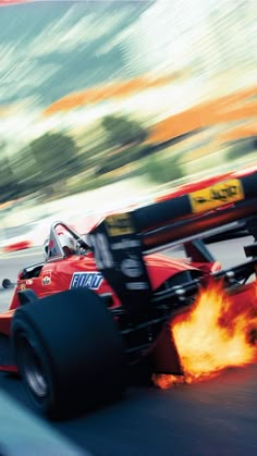 a red race car with flames coming out of it's tires