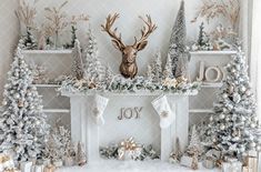 a fireplace decorated with christmas trees, stockings and deer's head on the mantel