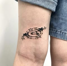 a woman's arm with stars and an eye tattoo on the left side of her leg