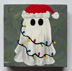 a painting of a ghost wearing a santa hat with christmas lights on it's face