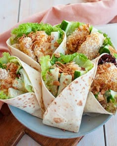 a plate filled with burritos on top of a wooden table