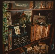 an old fashioned typewriter sitting on top of a book shelf