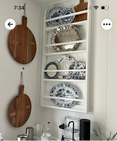 plates and cutting boards are hanging on the wall