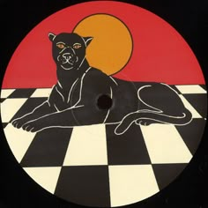 a black cat laying on top of a checkered floor