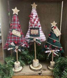 three small christmas trees are on display