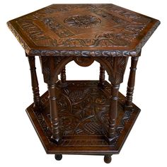 an ornate wooden table with carved designs on it