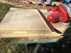 a table saw is sitting on top of a piece of wood in the process of being sanded