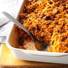 a casserole dish with spaghetti and meat in it