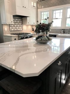 a large kitchen island with marble counter tops