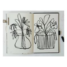 an open notebook with drawings of vases and flowers