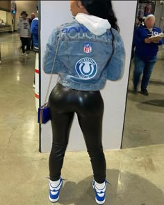 a woman in black leather pants and a jean jacket