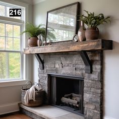 a stone fireplace with potted plants on top and a mirror over the mantel