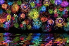 colorful fireworks are reflected in the water