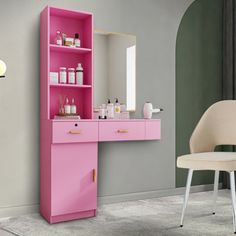 a bathroom with a pink vanity and chair next to the mirror on the wall in front of it