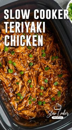 slow cooker teriyaki chicken in a black crock pot with green garnish