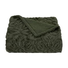 a green blanket with an intricate design on the top and bottom, folded in two rows