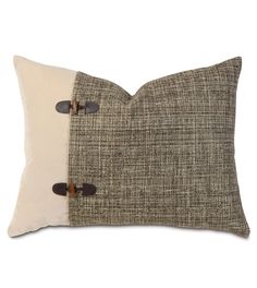 a brown and white pillow with two buttons on the front, one buttoned down