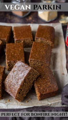 sliced brownies sitting on top of a piece of parchment paper next to a can of peanut butter