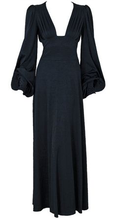 a black dress on a mannequin dummy with long sleeves and an open back