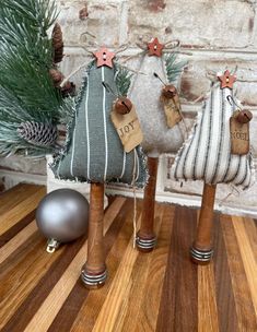 three small wooden ornaments are sitting on a table