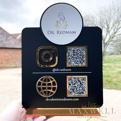 a person holding up a business card with qr code on it